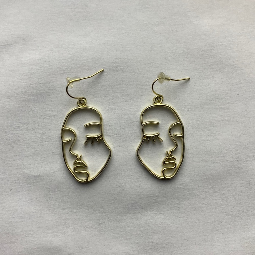 Gold face earrings